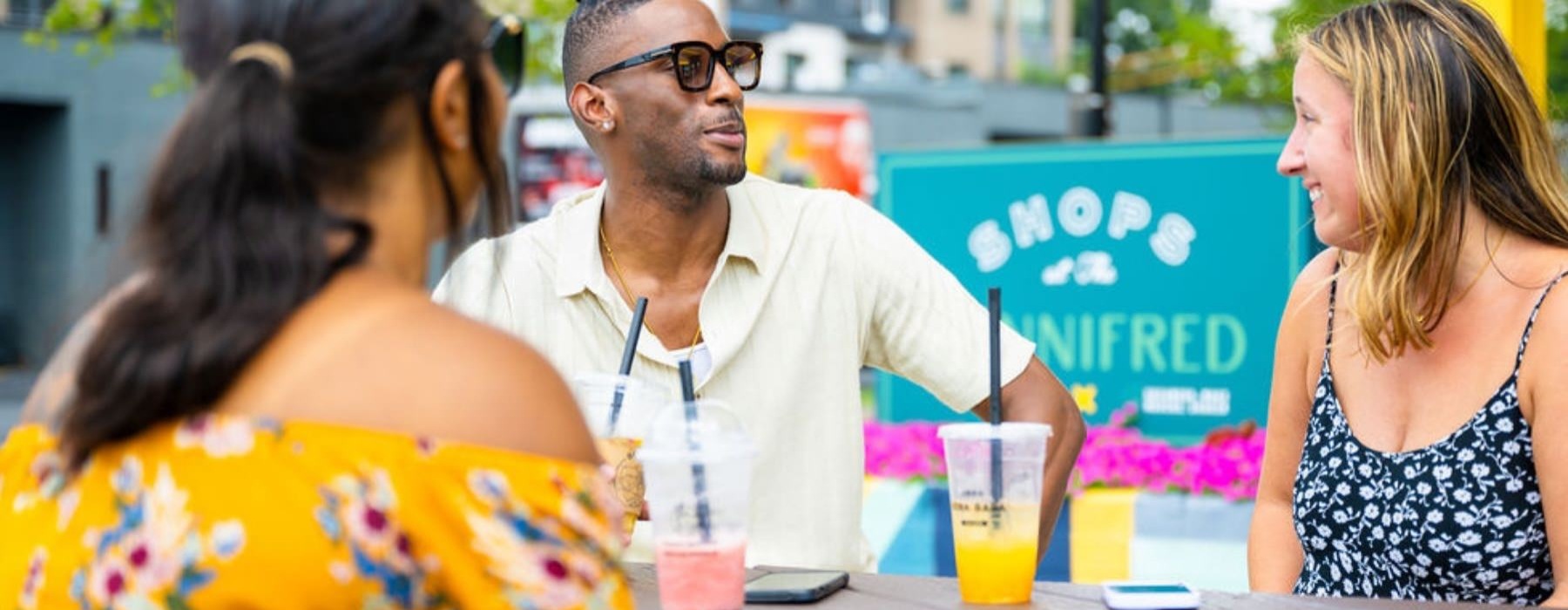 three people sitting down with drinks
