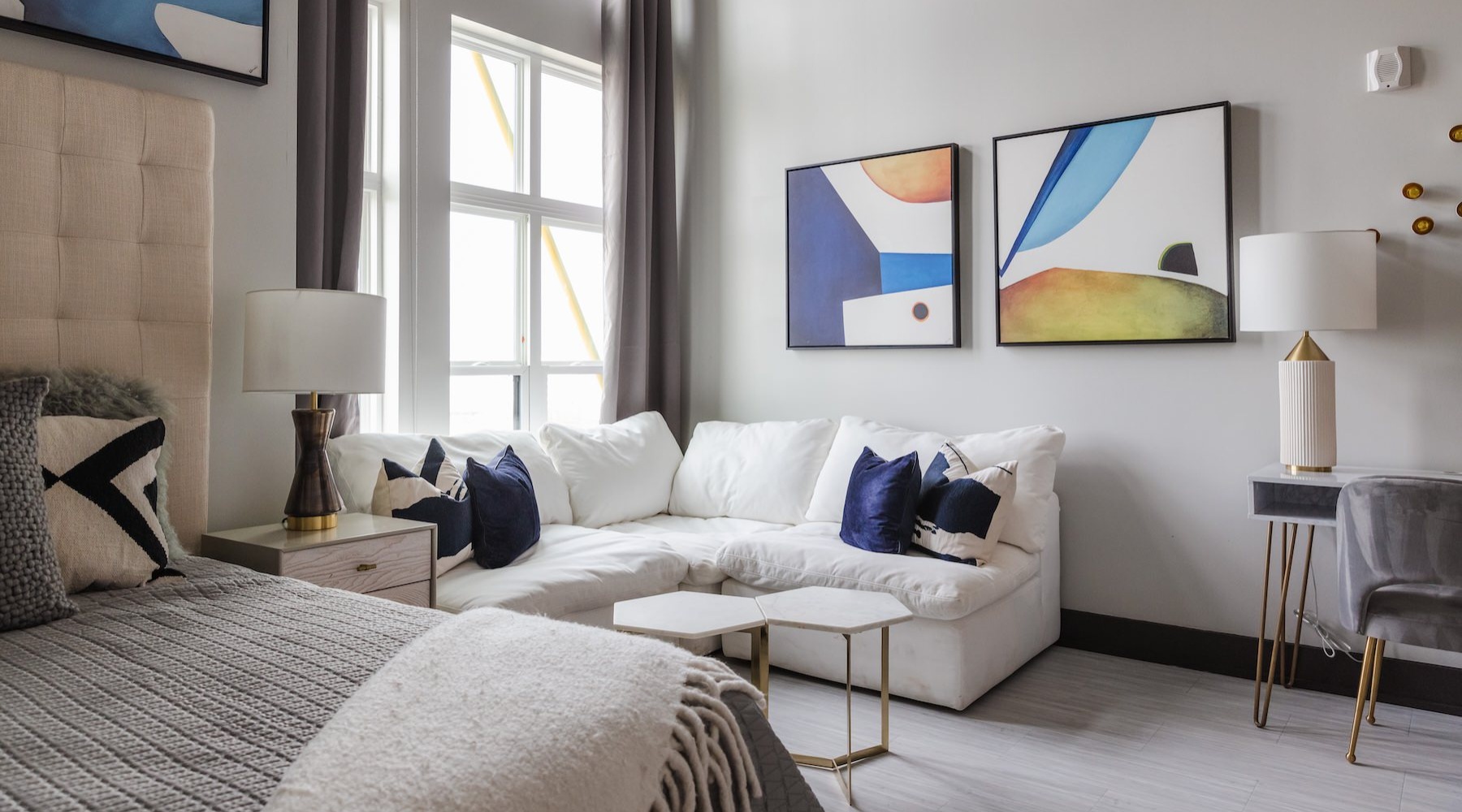 a room with a bed, couch and a table